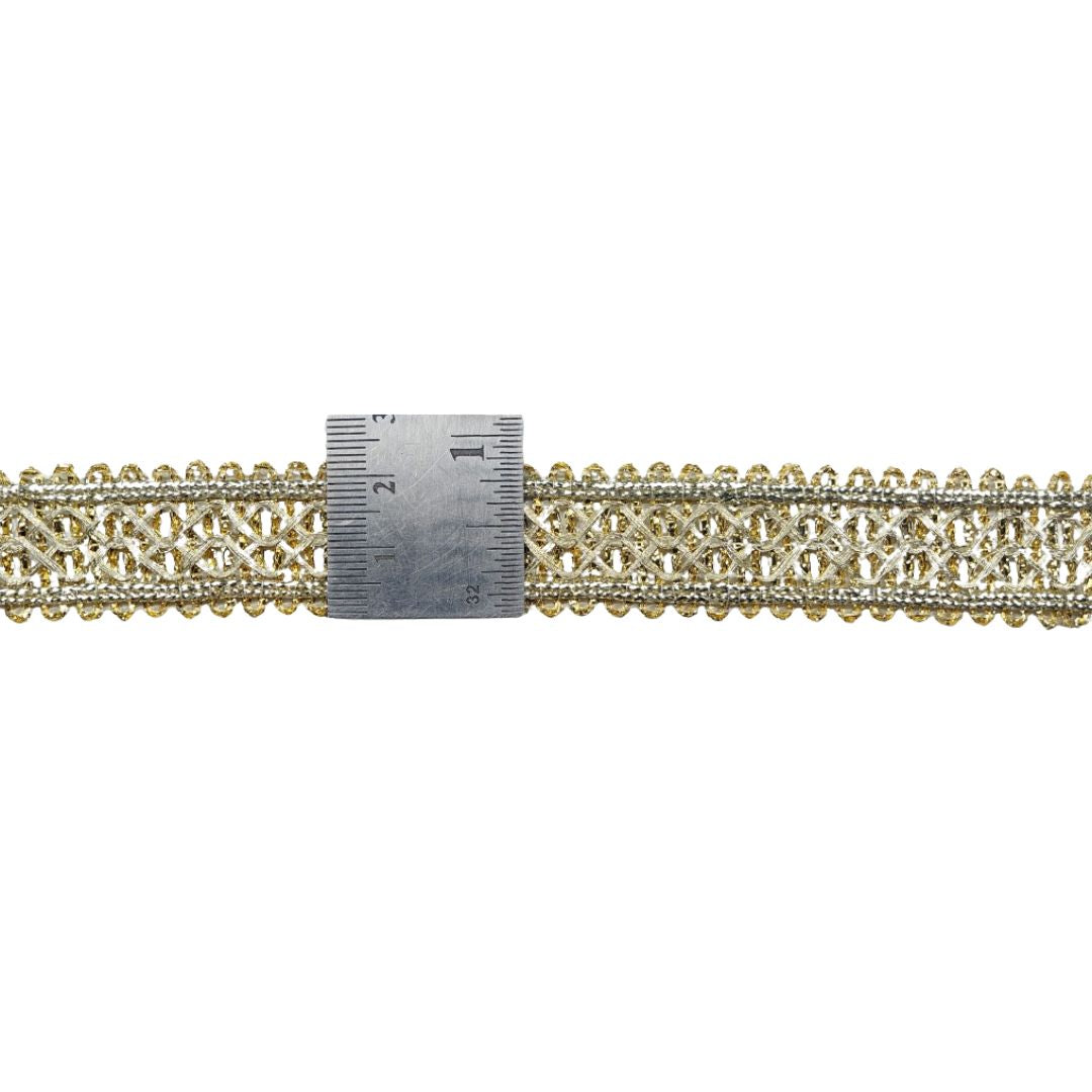 Gold chain with a measuring tape for scale on a white background